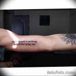 Фото тату ромашки и надписи "If you're still breathing you're the lucky one" на предплечье.