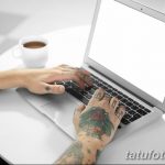 Фото тату: руки мужчины с татуировками, работающего за ноутбуком. Видны татуировки на пальцах, кистях и предплечьях.