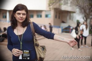 Фото тату: женщина с татуировкой в виде числового кода на внутренней стороне предплечья.