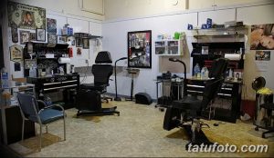 Фото современной тату-студии с двумя рабочими местами, удобными креслами, стеллажами с оборудованием и аксессуарами.