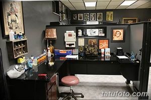 Фото рабочего места мастера тату с удобным столом, полками с материалами и эскизами, а также хорошим освещением.