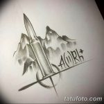 Фотография мужской татуировки с изображением группы крови A(II)RH+, стилизованной под пулю и брызги. Черно-серый рисунок, выполненный в реалистичной технике.