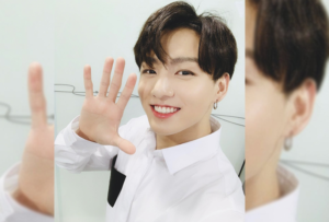Фотография участника группы BTS, Джунгука, с татуировкой на руке. Видна часть татуировки, выполненной черными чернилами.