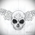 Фото тату эскиза черепа, окруженного розами, выполненного в стиле blackwork. Детализированный рисунок с использованием только черного цвета.