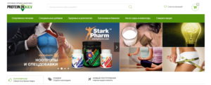 Фотография рекламного баннера спортивного питания Stark Pharm с изображением атлетичного мужчины и банок с добавками.