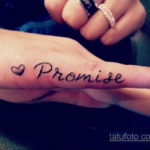 Фото тату: надпись "Promise" с изображением сердца на пальце руки. Романтичный и минималистичный рисунок татуировки.