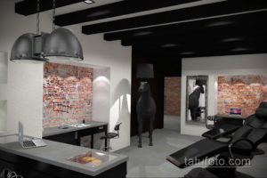 Фото интерьера современной тату-студии с кирпичной стеной, черной мебелью и стильным освещением. Профессиональное оборудование и комфортная обстановка.