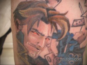 Фото тату Клауда Страйфа из Final Fantasy VII на руке. Детализированный портрет персонажа с красными глазами и темными волосами. Стиль реализм.