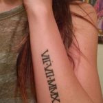 Фото тату: черные римские цифры 'VI-VII-MMX' на запястье, выполненные в строгом и лаконичном стиле.