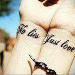 Фото парных татуировок на запястьях с надписью 'No Lies Just Love' выполненных черными чернилами. Изящный шрифт и минималистичный дизайн.