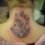 Фото тату дельфина и якоря на шее, выполненного в ярких цветах. Изящный рисунок с добавлением звезд и сердца.