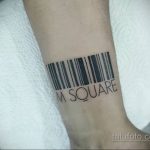 Черно-белое фото тату штрих-кода с надписью 'M SQUARE' на предплечье. Лаконичный дизайн, четкие линии, минимализм.