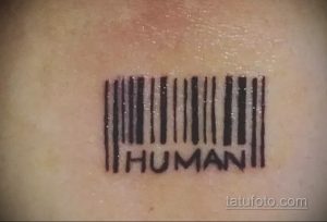 Фото тату штрихкода с надписью 'HUMAN' под ним. Черный рисунок татуировки выполнен в простом и минималистичном стиле.