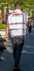 Фото татуировки на руке: детальное изображение религиозных символов, ангела и надписи в реалистичном стиле. Черно-белая татуировка.