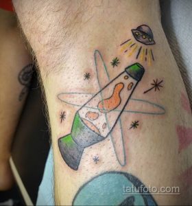 Необычное цветное тату на руке с изображением НЛО, светящейся колбы и звезд.