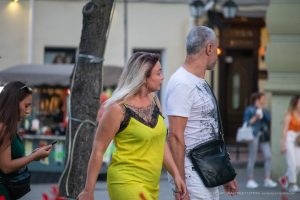 Фото тату на плече женщины: изящный рисунок с цветочными мотивами и кружевной отделкой, выполненный в нежных тонах.