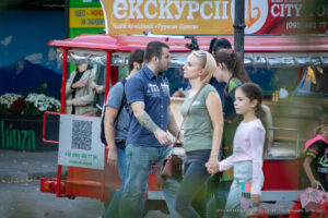 Фотография мужчины с татуировкой на руке, идущего рядом с женщиной на улице.