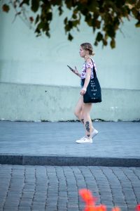 Фото тату на ноге девушки, изображающее изящный цветочный рисунок в черных тонах. Татуировка выполнена в минималистичном стиле и выглядит очень стильно.