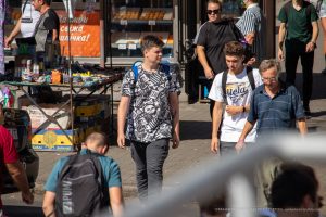 Фото тату на руке молодого человека. Яркий рисунок с черепами, узорами и надписями, выполненный в графическом стиле.