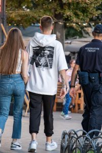 Фотография мужчины с татуировкой скелета на спине. Татуировка выполнена в чёрно-белой гамме и изображает скелет, держащий в руках оружие.