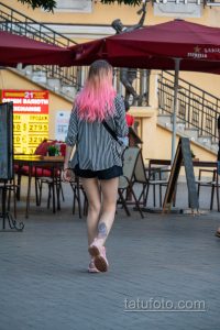 Фото тату на внутренней стороне бедра девушки. Цветной рисунок с изображением цветов и абстрактных элементов. Стильная и привлекательная татуировка.