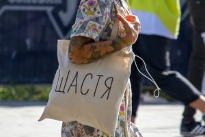 Фото тату на руке: крупный план красочного рисунка с цветами, птицами и листьями, выполненного в реалистичном стиле. Идеи для тату на предплечье.