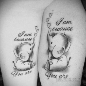Фото двух парных тату слонов на руках, с надписью 'I am because You are' и сердечками. Черно-белые татуировки с реалистичными деталями.