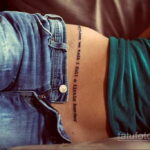 Фото тату на талии с минималистичной надписью 'sometimes we talk i fall a little harder'.