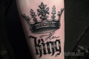 Фото тату на руке, изображающее корону и надпись "Her King". Выполнено в черно-серых тонах с детализированной проработкой.