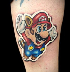 Фото тату: Марио из Super Mario Bros., радостное выражение лица, яркие цвета, на руке. Идеи для тату, посвященные видеоиграм.