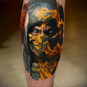 Фото татуировки Скорпиона из Mortal Kombat на икре, окруженного языками пламени. Динамичный и яркий рисунок.
