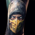 Фото татуировки Скорпиона из Mortal Kombat на руке. Детализированный портрет персонажа с проработанной маской и взглядом.