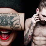 Фото тату с изображением фотоаппарата, закрывающего глаза девушки. Также на фото видны татуировки на руках и груди мужчины.