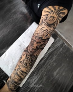 Фото тату на руке: молящиеся руки, голубь, надпись 'Faith', розы и другие религиозные символы в черно-белом стиле.