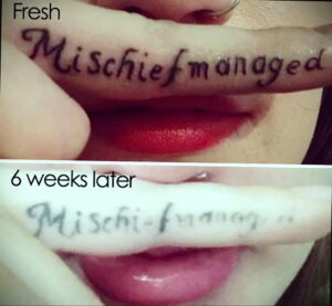 Фото татуировки с надписью 'Mischief managed' на губе, показывающее выцветание и размытие чернил через 6 недель.