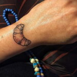Фото татуировки круассан 05.06.2021 №025 - croissant tattoo - tatufoto.com