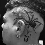 Фото тату паука в паутине на голове. Рисунок выполнен в технике blackwork с использованием только черного цвета.
