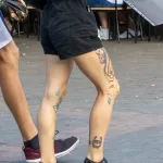 Колоритная молодая девушка с тату цветы на руку и тату подкова с глазом на ноге - Уличная тату (street tattoo) № 14–210821 2