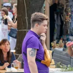 Фото тату котенка с веточками на руке. Черно-белый рисунок татуировки в реалистичном стиле, выполненный с высокой детализацией.