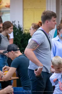 Фото тату в стиле трайбл на руке. Черно-серая татуировка с геометрическими узорами и сложной структурой.