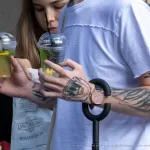 Тату с монашкой и надписью SELL ARTS BUY DRUGS на левой руке парня - Уличная тату (street tattoo) № 14–210821 4
