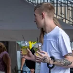 Тату с монашкой и надписью SELL ARTS BUY DRUGS на левой руке парня - Уличная тату (street tattoo) № 14–210821 5