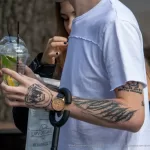 Тату с монашкой и надписью SELL ARTS BUY DRUGS на левой руке парня - Уличная тату (street tattoo) № 14–210821 6