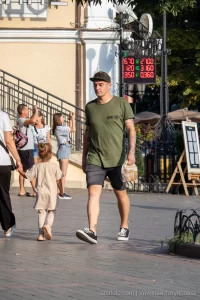 Фото тату: рукав татуировки, покрывающий руку, с изображением реалистичных цветов и узоров. Детализированный рисунок татуировки в теплых тонах.