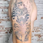 Фото татуировки Анубиса, выполненной в технике dotwork. Изображение бога с головой шакала, созданное из множества точек. Современный стиль тату.