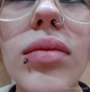 Фото пирсинга губы: серебряный лабрет с небольшим украшением на нижней губе.