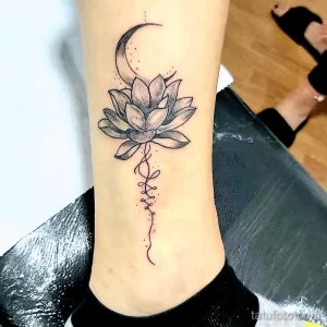 Фото тату: изображение лотоса и полумесяца на лодыжке, выполненное в технике blackwork. Изящный и символичный рисунок.