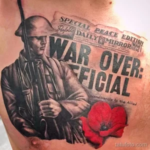 Фото тату на груди с изображением солдата и газеты 'War Over'. Реалистичный рисунок татуировки, выполненный в черно-красной гамме.