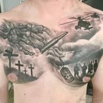 Фото тату на груди и плече с изображением ангела-хранителя, солдат, вертолета и крестов на фоне поля боя.
