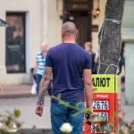 Фото тату на руке мужчины, рука полностью покрыта рисунком, уличная фотография, детализированный рисунок татуировки, мастер тату, реализм.